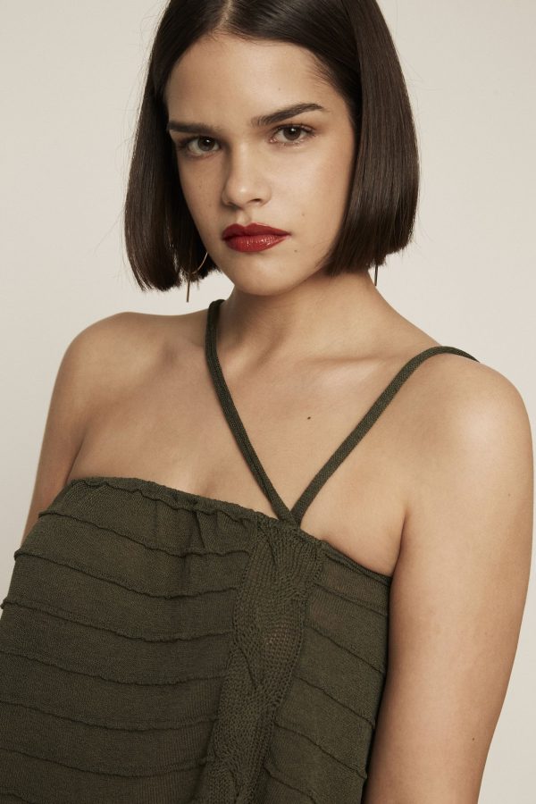 Deep green knit crop top. Featuring texture, braided details and straps with strings.