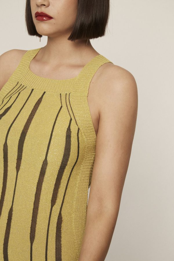 Short lime knit dress with textured straps and trims and contrasting see-through motifs.