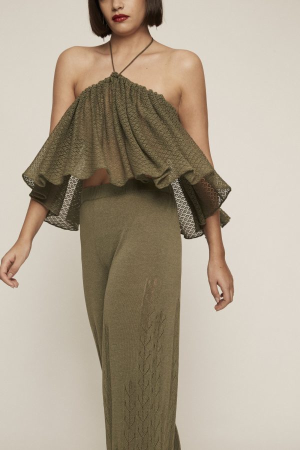 An absolute show-stopper. Dare to wear this draped tail-hem green knit crop top, which features a see-through texture and V strap
