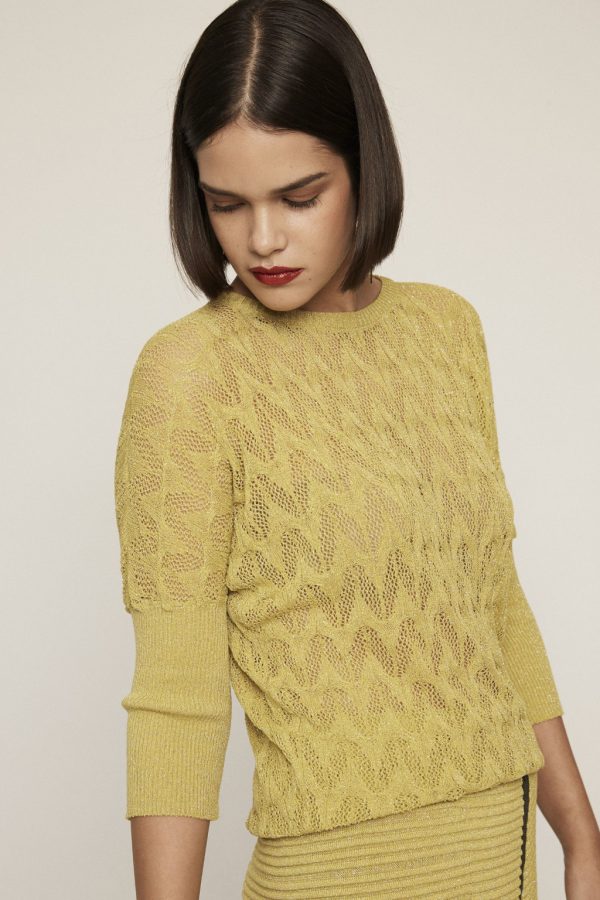 Shimmery lime knit top. Featuring round neckline, see-through motifs and 3/4 slightly puffed sleeves.